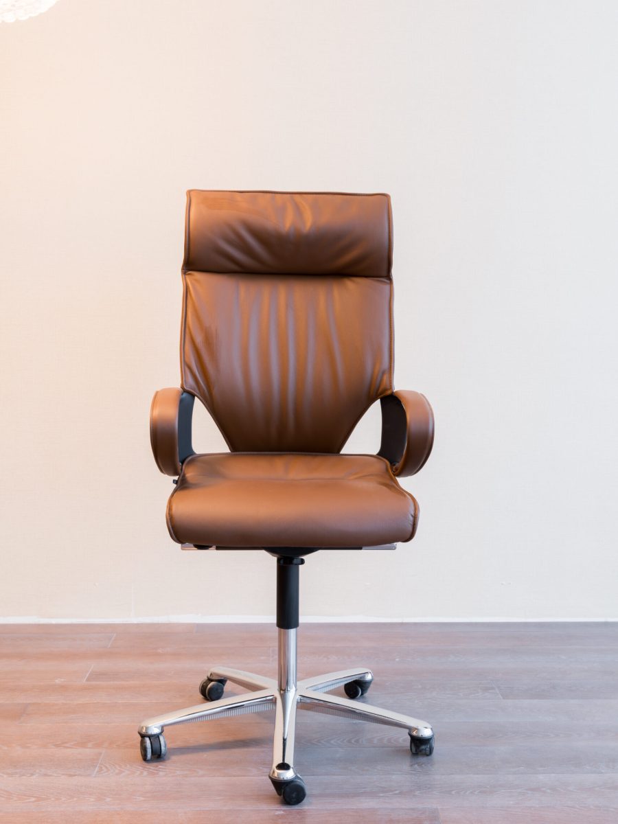 Comfortable office chair with leather upholstery and shiny legs
